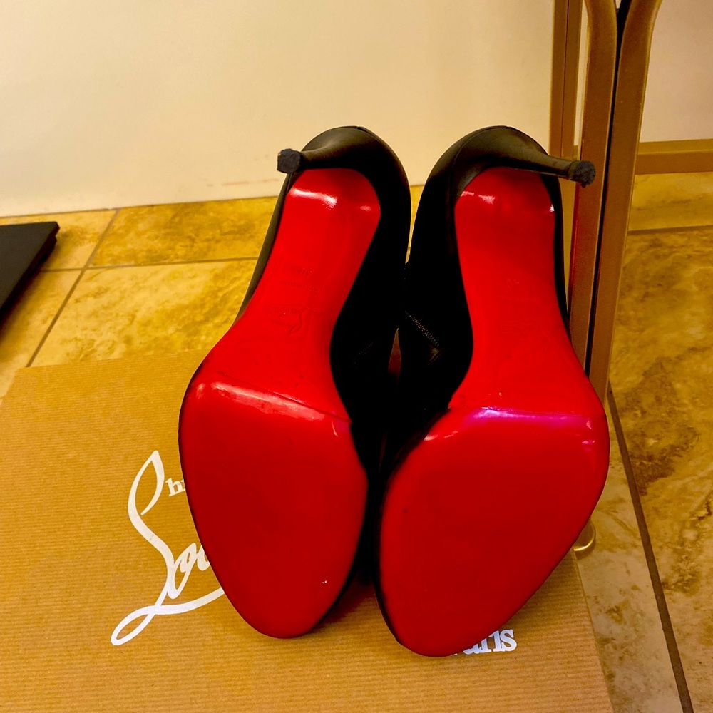Red Bottom Booties all leather black with zipper on the inner side.
